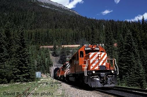 CPR locomotive exits Lower Spiral Tunnel, about 1100 feet in diameter. Trains over 85 cars pass over themselves, as shown here. David R. Spencer photo