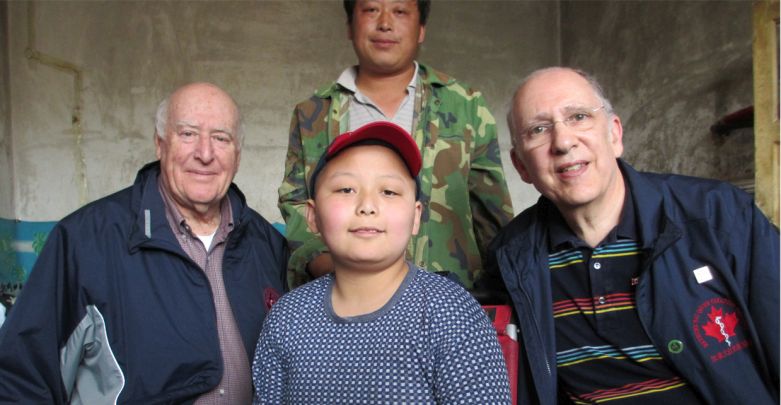 Dr. Grant Stewart, retired trauma surgeon from Vancouver, and Dr. John Ducas, cardiologist from Winnipeg, with Zhen Yi and his dad in 2012